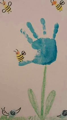 a child's handprint with two bees on it