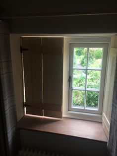 an open window in the corner of a room