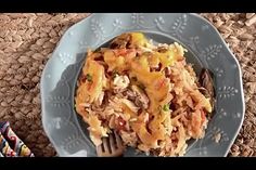 a blue plate topped with rice and meat