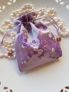 These are Gorgeous Lux silk bags in a beautiful shade of Soft Mauve, they feature a Lovely Cherry Blossom design stitched in beautiful Purples and White tones, truly elegant. The silk bags are lined inside and have a Satin draw string which makes them easy to use, and they have two nice wooden beads as a feature. The bags are approximately 11.5cm Wide and 14.5cm in length. There maybe slight variation in size of the bag and placement of the beautiful print as these were handmade. The Silk fabric is Beautiful and Lush and are perfect to elevate your Gift giving. Elegant Purple Bag Gift, Purple Embroidered Bag For Gift, Elegant Potli Bag For Gifts, Cherry Blossom Design, Pouch Bags, Silk Bag, Blossom Design, Drawstring Pouch, Coin Purses