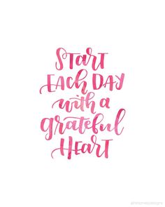 the words start each day with a grateful heart in pink ink on a white background