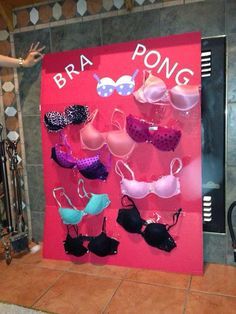 an advertisement for bras is displayed in front of a pink sign that says bra pong