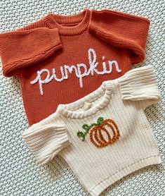 two knitted sweaters with pumpkin embroidered on them