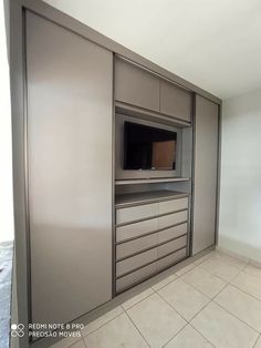 an empty room with cabinets and a flat screen tv