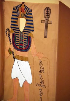 an egyptian painting on the wall in a room with a door open to reveal it