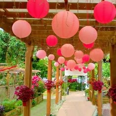 the walkway is lined with pink lanterns and flowers