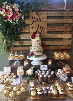 a table topped with lots of cakes and cupcakes