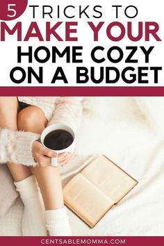 a woman sitting on her bed holding a cup of coffee and an open book with the title 5 tricks to make your home cozy on a budget