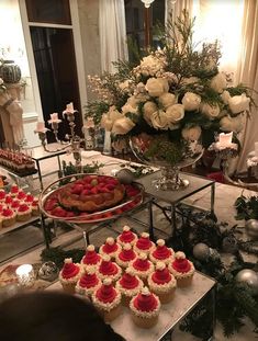 a table filled with cakes and cupcakes on top of plates