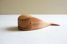 a wooden toy whale sitting on top of a table