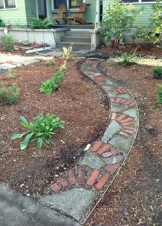 a garden path in front of a house