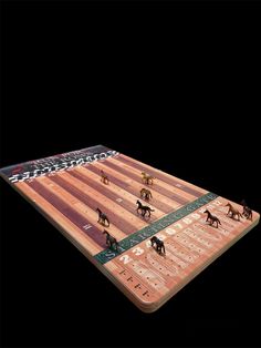 a wooden board game with horses on it