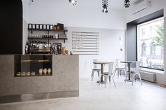 the interior of a coffee shop with tables and chairs