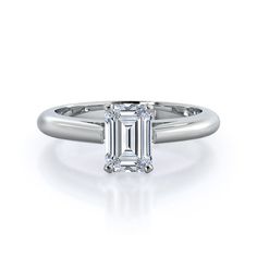 an emerald - cut diamond ring on a white background