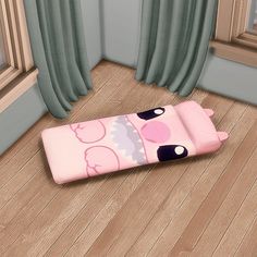 a pink sleeping bag sitting on top of a wooden floor next to a window with curtains