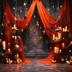 a room with red curtains, candles and stars hanging from it's ceiling in the center