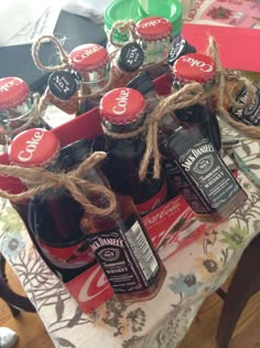 several bottles of beer are sitting on a table with some twine rope around them