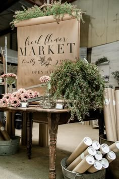 an outdoor market with flowers and candles on the table