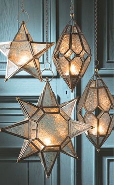 three star lights hanging from chains in front of a door