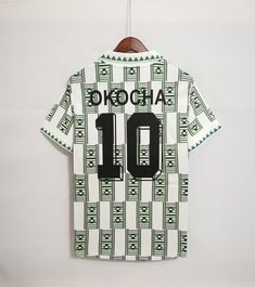 a shirt hanging on a wall with the number 10 printed on it and an inscription that reads