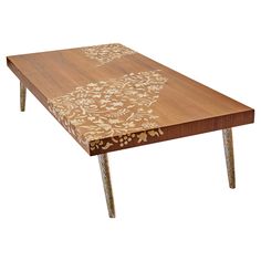 a wooden table with floral designs on it