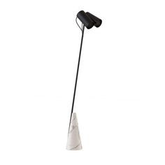 a black and white floor lamp sitting on top of a table