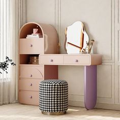 a pink vanity table with a mirror and stool