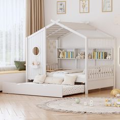 a child's bedroom with white furniture and decor