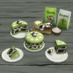 the cake is decorated with green and white icing, along with other items on plates