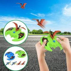 a hand holding a green toy with flying birds in the sky above it and another person's hands reaching for an object