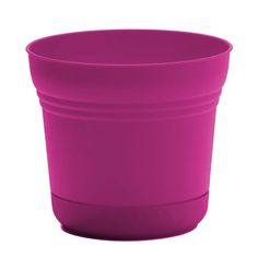 a pink plastic cup sitting on top of a white table