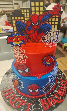 three tiered cake decorated with spiderman decorations