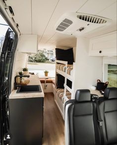 an interior view of a camper with bunk beds and kitchen area in the back