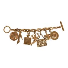 This 80's iconic vintage Chanel lucky charms bracelet features a 24K gold plated chain link with seven of Chanel's "iconic" lucky charms including a clover, shoe, perfume bottle, cherub, Chanel quilted handbag, turtle, and camellia flower. It also has a bar toggle and loop closure.Origin: FranceCondition: Vintage; Very Good - The charm bracelet shows sign of wear with scratching throughout. Some of the charms have chipped/peeled around the corners. There's some discoloration.Measurements: Length Luxury Vintage Style Jewelry With Vintage Charm, Classic Luxury Gold Charm Bracelet, Shoe Perfume, Vintage Chanel Jewelry, Lucky Charm Bracelet, Quilted Handbag, Camellia Flower, Charms Bracelet, Gold Charm Bracelet