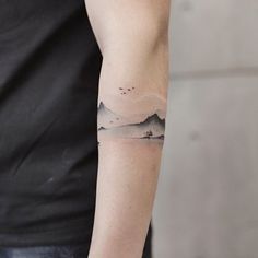 a man with a small tattoo on his arm