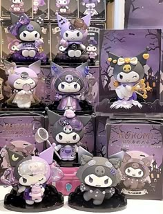 many little figurines are on display in front of purple and black packagings