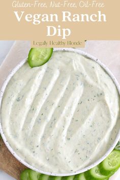 a bowl filled with ranch dip surrounded by cucumbers