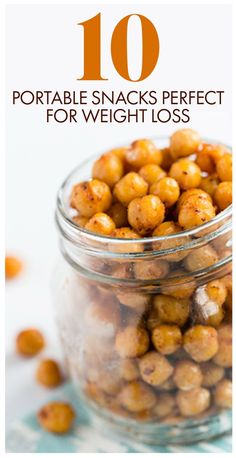 a glass jar filled with peanuts sitting on top of a table