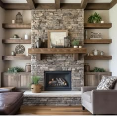 a living room filled with lots of furniture and a fire place in front of a stone fireplace