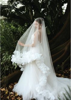 a woman in a white wedding dress and veil