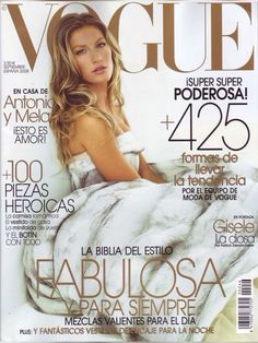 a magazine cover with a beautiful woman laying on top of a white bed covered in blankets