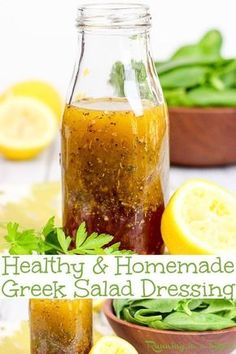 a jar full of homemade greek salad dressing next to some lemons and green beans