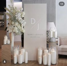 candles and flowers are on the table in front of a sign that says dean & jessica welcome you