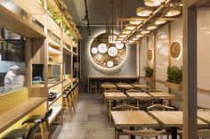 an empty restaurant with wooden tables and chairs