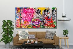 a living room with a couch, coffee table and large painting on the wall above it