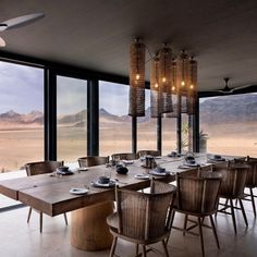 a dining room with large windows overlooking the desert