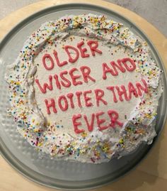 a birthday cake with frosting and sprinkles that says older wise and hotel than ever