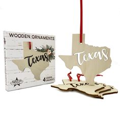 a wooden ornament with the word texas on it next to a boxed box