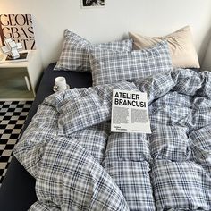 a bed that has some pillows on top of it and a sign in the middle