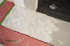 a bathroom floor that is being remodeled with tile and grouting on the ground